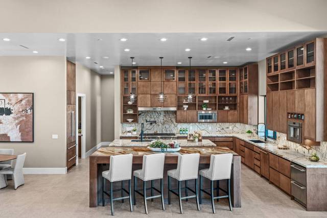 The culinary space is defined by natural stone, with eye-catching, bold veining and dramatic pa ...