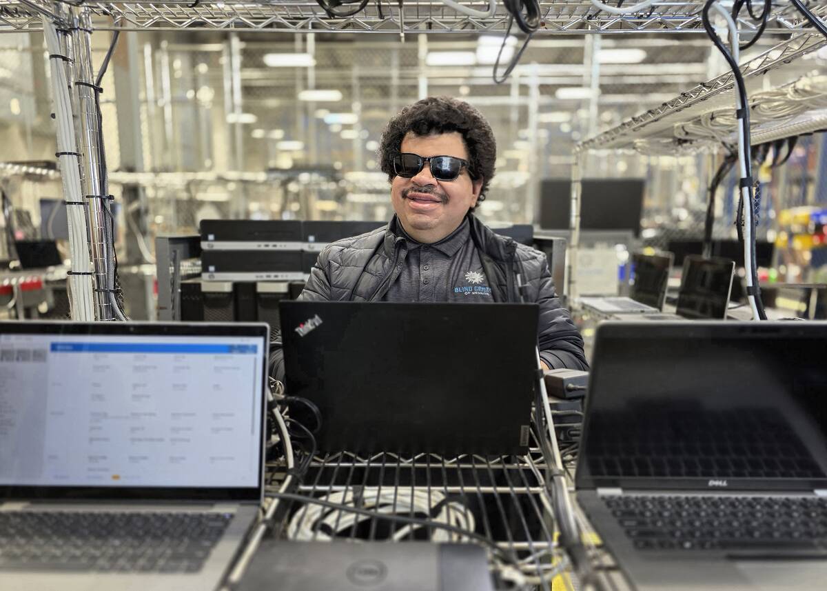 Cristobal Sotelo diagnoses issues in the Tech Department at The Blind Center of Nevada’s Elec ...