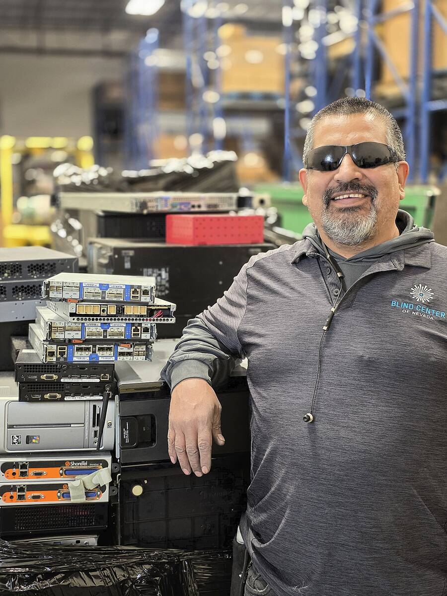 Juan Reyes standing in front of electronics that will be dismantled at The Blind Center of Neva ...