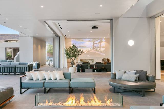 The great room includes a fire feature. (Courtesy of IS Luxury)