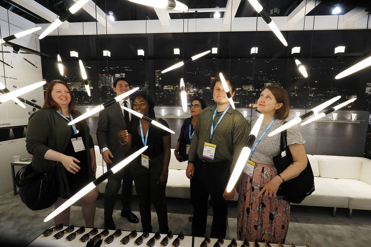LightFair convention-goers look at futuristic light displays. (Photos courtesy of Messe Frankfu ...