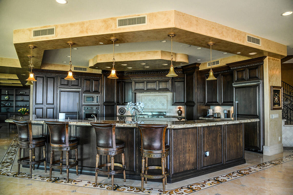 The One Queensridge Place penthouse features a unique island with seating. (Realty ONE Group)
