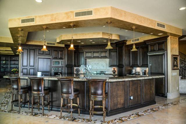 The One Queensridge Place penthouse features a unique island with seating. (Realty ONE Group)