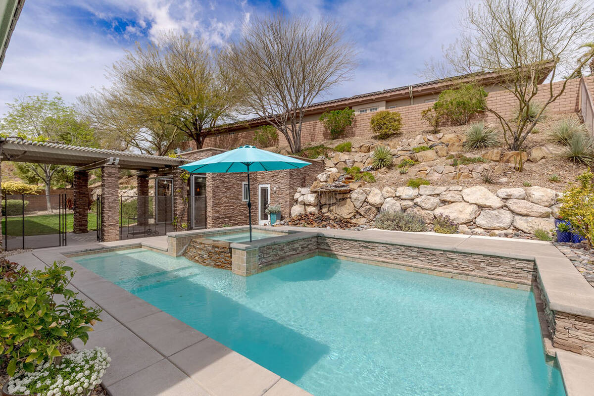 The pool and elevated hot tub are on one side of the casita, with a grassy area on the other. T ...