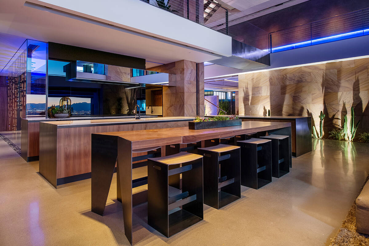 The modern kitchen features several islands with seating and upgraded appliances. (Douglas Ell ...