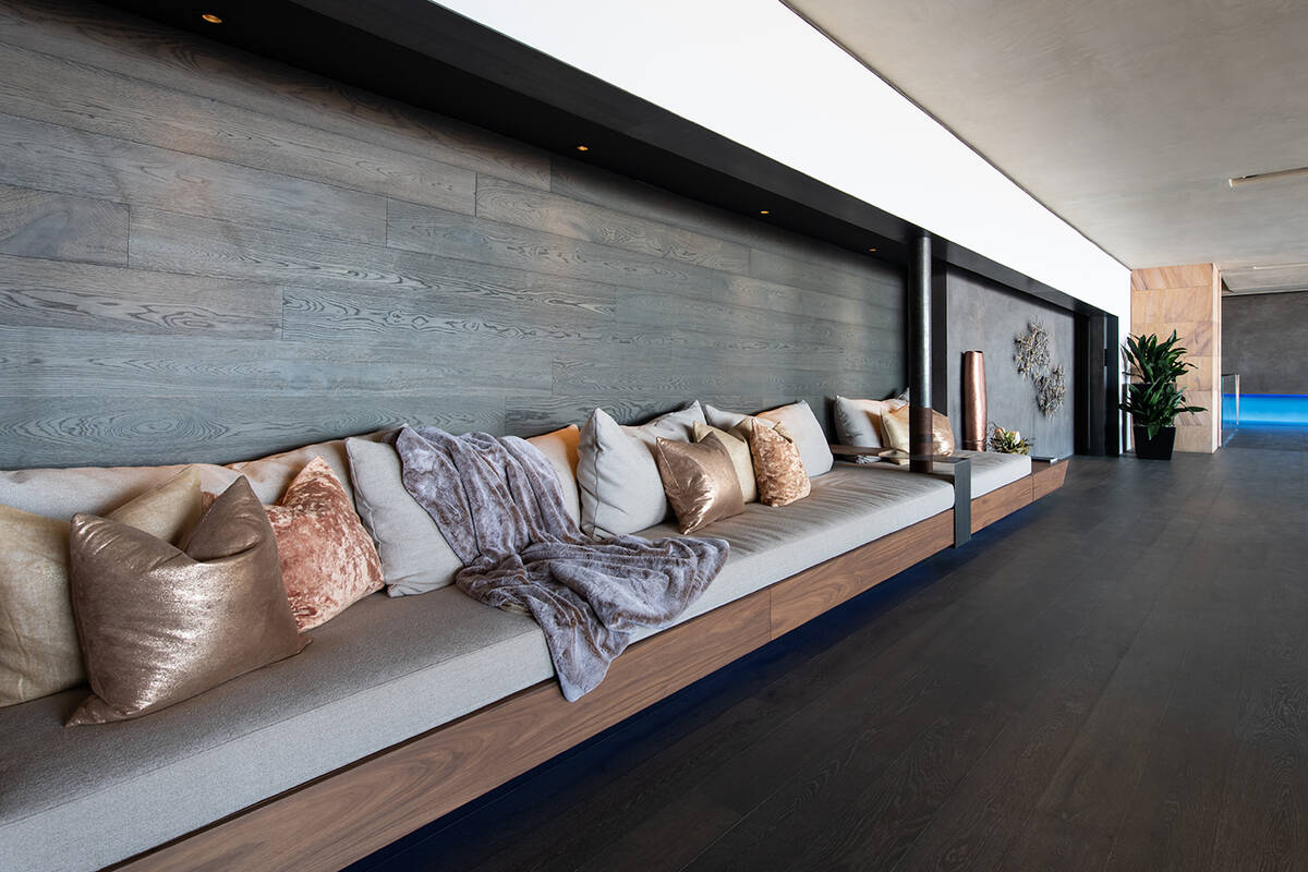 The home’s second-level billiards room features built-in couches, cozy furnishings and bevera ...