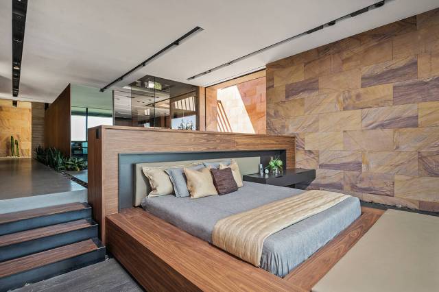 The private master retreat features metaquartzite stone walls, a beverage bar and expansive wal ...