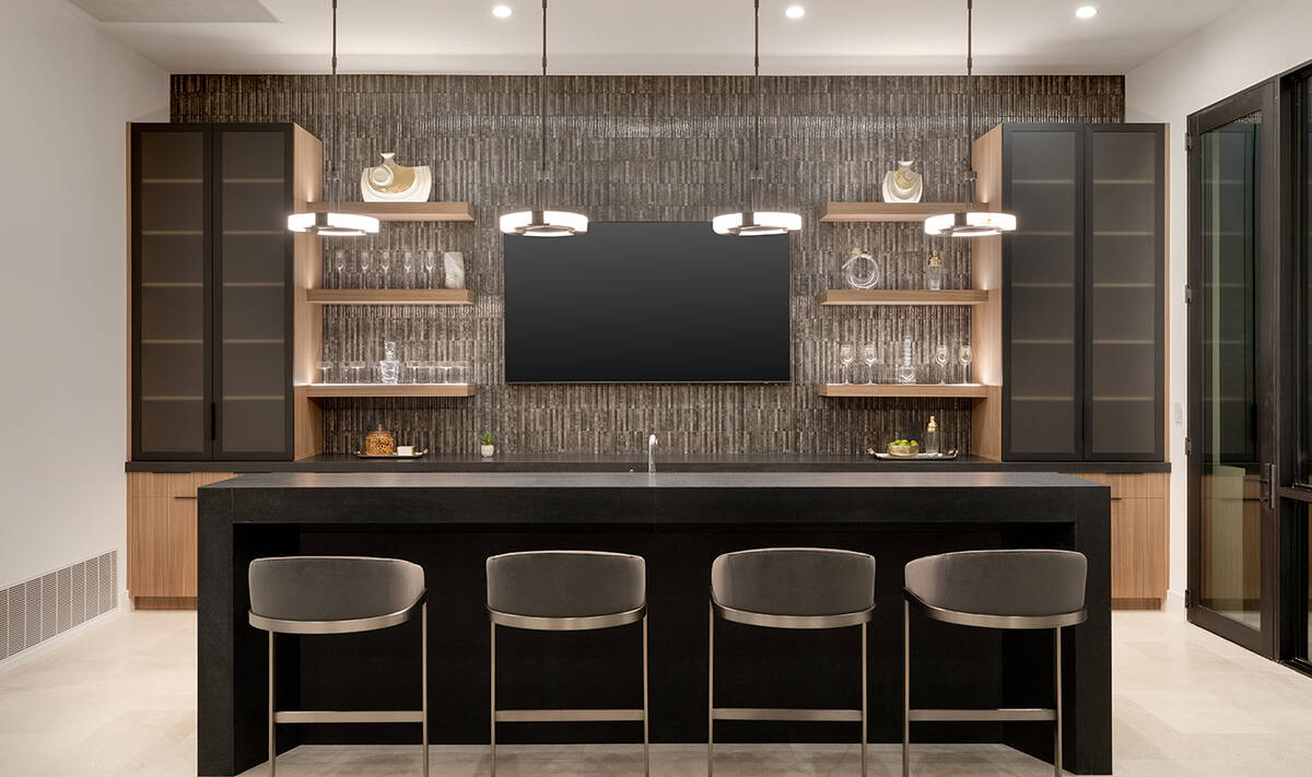 The Summit home's kitchen has all the top-tier appliances, such as double ovens, built-in espre ...