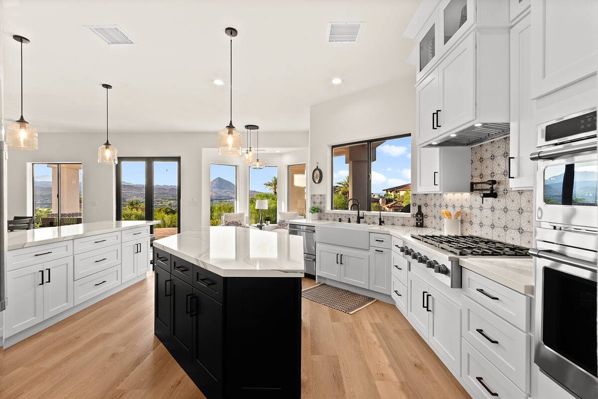 The chef’s kitchen features custom cabinetry, quartz countertops and stainless-steel applianc ...