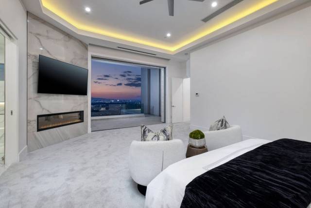 Situated just off the main living area, the private primary bedroom resembles a luxurious hotel ...