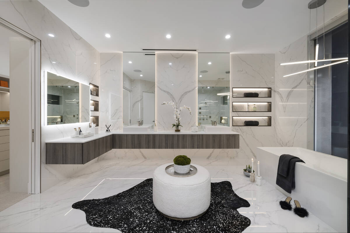 The elegant spa bath showcases a walk-in shower, floating vanities and a soaking tub with stunn ...
