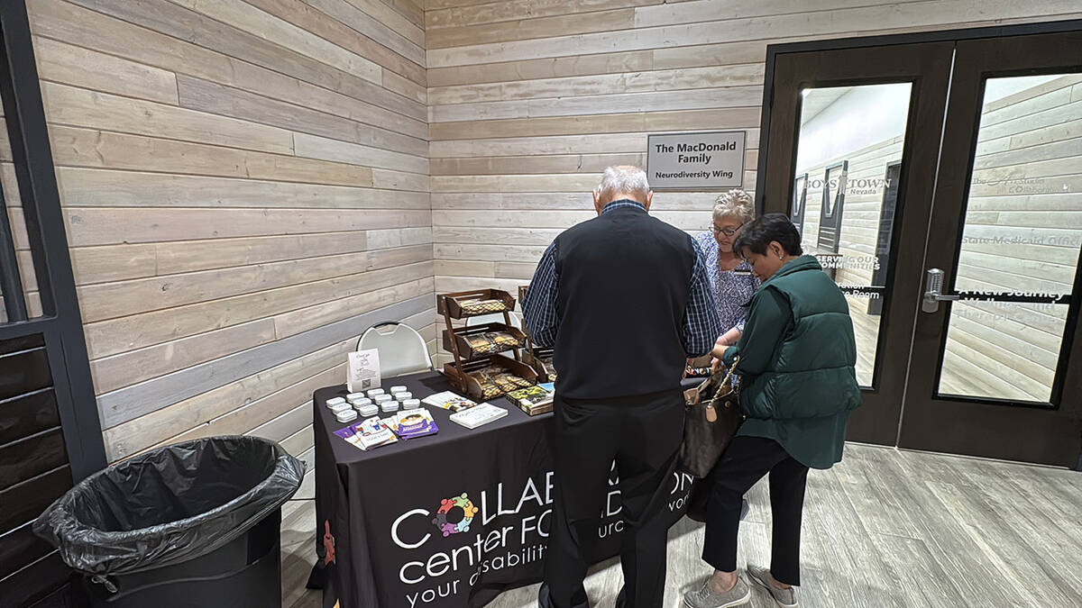 Guests stop by the information table at CollabCafé in Collaboration Center Foundation. The caf ...