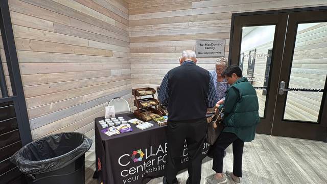 Guests stop by the information table at CollabCafé in Collaboration Center Foundation. The caf ...