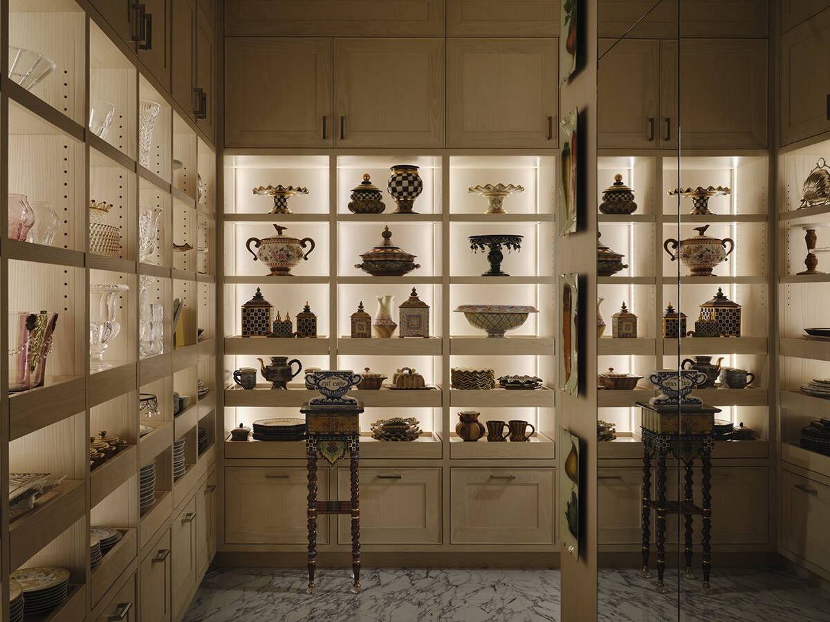 The walk-in closet, with custom cabinetry and shelving, emulates a high-end boutique. (Courtesy ...