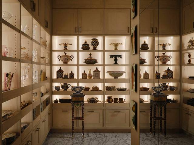 The walk-in closet, with custom cabinetry and shelving, emulates a high-end boutique. (Courtesy ...