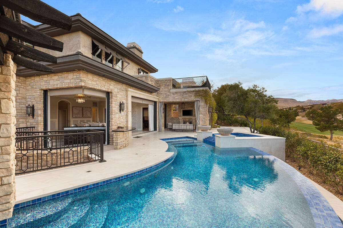 This three-story custom estate in The Ridges offers privacy and elegance with golf course front ...