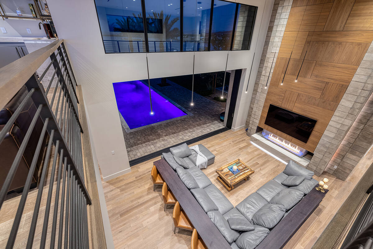 The centerpiece of the great room is a voluminous two-story fireplace with a walnut surround, b ...