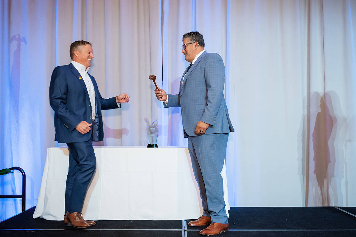 At right, outgoing SNHBA President Carlos Zuluaga, vice president of operations at Tri Pointe H ...