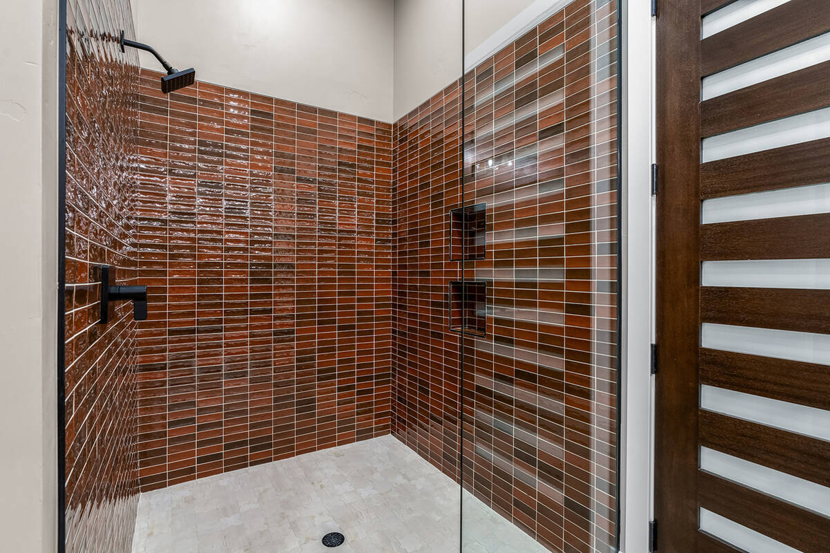 In the Ascaya estate, the homeowners selected different colors for the two primary baths. The m ...